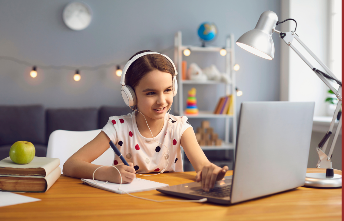 Girl with headphones using laptop